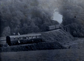 Camping coach and train going into tunnel